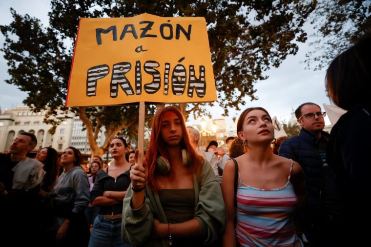 A woman holds a placard that reads "Mazon in prison", as civil groups and unions protest against the management of the emergency response to the deadly floods in eastern Spain, in Valencia, Spain, November 9, 2024. REUTERS/Eva Manez