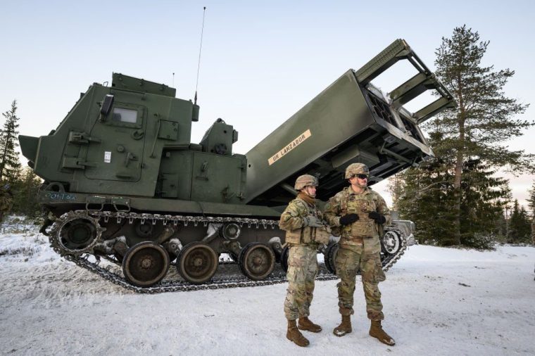 ROVANIEMI, FINLAND - NOVEMBER 20: Members of multinational artillery teams stand with an MLRS M270 A2 mobile rocket system during the NATO "Exercise Lightning Strike" on November 20, 2024 near Heinu, Finland. The live-fire exercise includes service members from 28 Allied and partner nations, and is taking place between November 4-24, across locations in Finland, Estonia, Germany, Poland, and Romania. (Photo by Leon Neal/Getty Images)