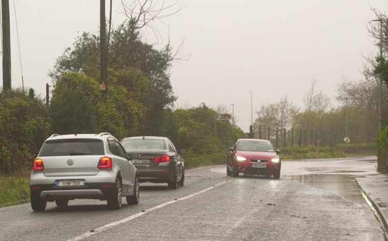 A car is driven past a flooded road at Passage West, Co Cork. Storm Bert is battering the country with strong winds, heavy rain and snow and ice with amber warnings coming into force bringing a "potential risk to life and property". Picture date: Saturday November 23, 2024. PA Photo. See PA story WEATHER Bert. Photo credit should read: Noel Sweeney/PA Wire