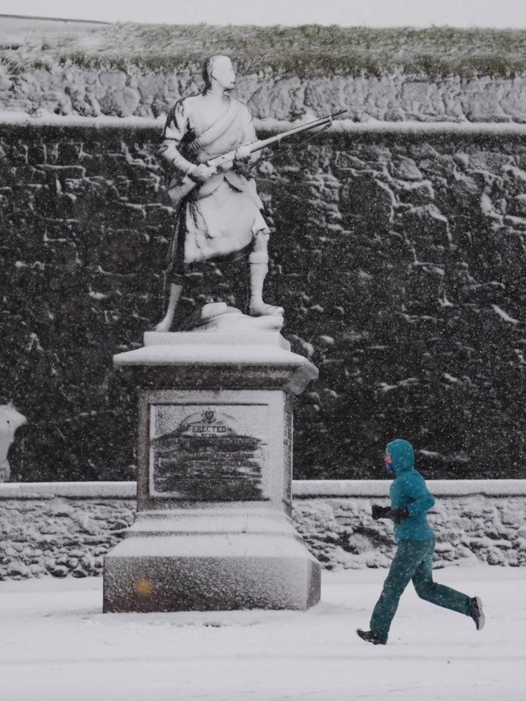 A person runs in the snow at Stirling Castle, Stirling, Scotland. Storm Bert is battering the country with strong winds, heavy rain and snow and ice with amber warnings coming into force bringing a "potential risk to life and property". Picture date: Saturday November 23, 2024. PA Photo. See PA story WEATHER Bert . Photo credit should read: Andrew Milligan/PA Wire