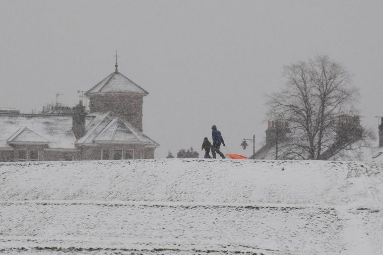 People walk in the snow at Stirling Castle, Stirling, Scotland. Storm Bert is battering the country with strong winds, heavy rain and snow and ice with amber warnings coming into force bringing a "potential risk to life and property". Picture date: Saturday November 23, 2024. PA Photo. See PA story WEATHER Bert . Photo credit should read: Andrew Milligan/PA Wire