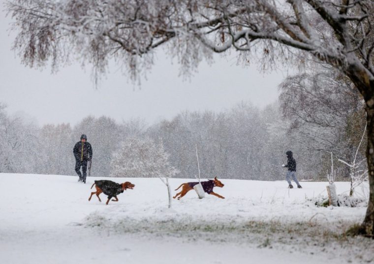 People out walking during heavy snowfall at Bannockburn, near Stirling. Storm Bert is battering the country with strong winds, heavy rain and snow and ice with amber warnings coming into force bringing a "potential risk to life and property". Picture date: Saturday November 23, 2024. PA Photo. See PA story WEATHER Bert. Photo credit should read: Robert Perry/PA Wire