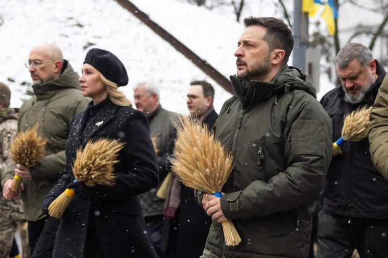 In this handout photograph taken and released by the Ukrainian Presidential Press Service on November 23, 2024, Ukraine's President Volodymyr Zelensky (R) and his wife Olena Zelenska (L) pay tribute to the victims of the famine of 1932-1933 at the National Museum of the Holodomor-Genocide in Kyiv. (Photo by Handout / UKRAINIAN PRESIDENTIAL PRESS SERVICE / AFP) / RESTRICTED TO EDITORIAL USE - MANDATORY CREDIT "AFP PHOTO / UKRAINIAN PRESIDENTIAL PRESS SERVICE" - NO MARKETING NO ADVERTISING CAMPAIGNS - DISTRIBUTED AS A SERVICE TO CLIENTS (Photo by HANDOUT/UKRAINIAN PRESIDENTIAL PRESS SERVICE/AFP via Getty Images)