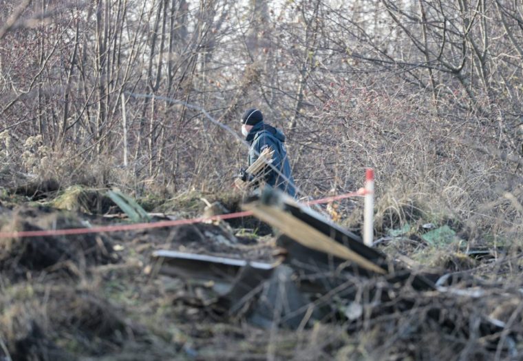 Lithuanian police search the area where a DHL cargo plane crashed near the Vilnius International Airport in Vilnius on November 25, 2024. A DHL cargo plane crashed early on November 25, 2024 near the airport in Lithuania's capital, killing one person, authorities said as they searched for clues to what caused the tragedy. Lithuanian officials, who in the past weeks have been probing alleged acts of sending incendiary devices on Western-bound cargo planes, stopped short of linking the crash with that investigation. (Photo by Petras Malukas / AFP) (Photo by PETRAS MALUKAS/AFP via Getty Images)