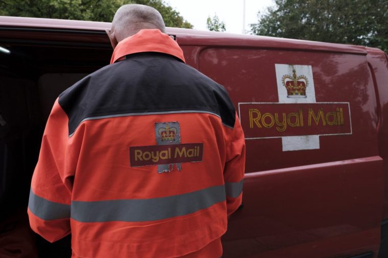 An employee of formerly state-owned postal service Royal Mail sorts parcels and letters in the back of his delivery van baring the postage company's signage as the group faces fresh legal troubles over its bulk delivery services on 29th May, 2024 in Southport, United Kingdom. New legal claims from competitors amounting to nearly ??900 million loom over the group following allegations of anti-competitive behaviour that boosted prices. (photo by Daniel Harvey Gonzalez/In Pictures via Getty Images)