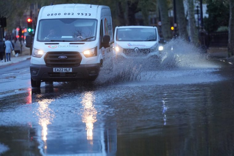 Vehicles drive through floodwater on Victoria Embankment in central London. Trains have been cancelled in parts of southern England after heavy rainfall flooded railway lines during Storm Conall. It comes just days after Storm Bert left hundreds of homes flooded, turned roads into rivers and saw winds of more than 80mph. Picture date: Wednesday November 27, 2024. PA Photo. See PA story WEATHER Conall. Photo credit should read: Yui Mok/PA Wire