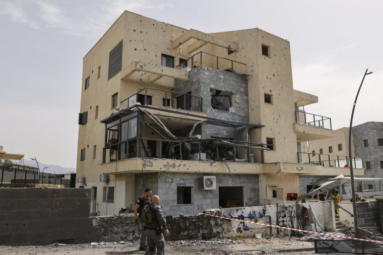 Israeli forces check a building that was hit by a Hezbollah rocket in Kiryat Shmona in northern Israel near the Lebanon border, on March 27, 2024. A civilian was killed on March 27 in northern Israel, medics say, after Lebanon's Hezbollah launched a barrage of rockets into Israel in retaliation for an overnight strike that killed "seven rescuers". (Photo by Jalaa MAREY / AFP) (Photo by JALAA MAREY/AFP via Getty Images)