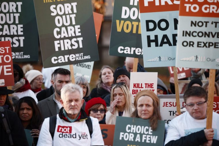 Campaigners against the assisted suicide bill react after the bill to legalise euthanasia in the UK is passed, outside The Palace of Westminster in central London, on November 29, 2024. British lawmakers voted in favour of an assisted-dying bill for England and Wales on Friday, allowing the proposed legislation to progress to the next stage of parliamentary scrutiny. MPS voted by 330 to 275 in support of legalised euthanasia in the first vote on the issue in the House of Commons for nearly a decade, following an emotive debate that lasted almost five hours. (Photo by BENJAMIN CREMEL / AFP) (Photo by BENJAMIN CREMEL/AFP via Getty Images)