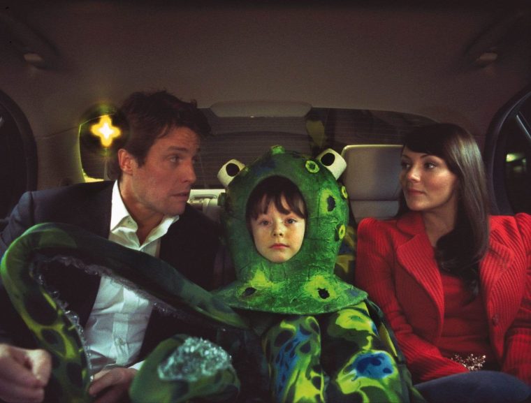 Film : Love Actually (2003). Pictured: THE PRIME MINISTER (HUGH GRANT), KEITH (BILLY CAMPBELL), NATALIE (MARTINE McCUTCHEON). Photo Credit: Peter Mountain. Copyright: 2003 Universal Studios. ALL RIGHTS RESERVED.