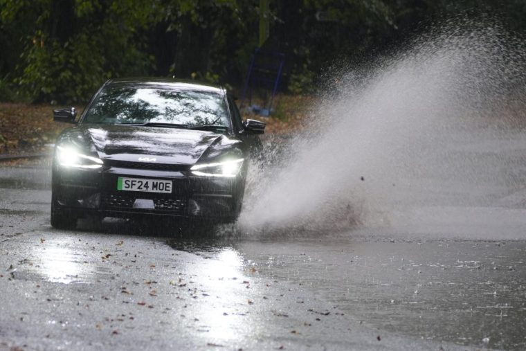 A car driving in flood water in Sefton Park in Liverpool. Heavy rain is set to continue as two fresh weather warnings come into force on Monday, potentially bringing more flooding and travel disruption. Picture date: Monday September 30, 2024. PA Photo. See PA story WEATHER Rain. Photo credit should read: Peter Byrne/PA Wire