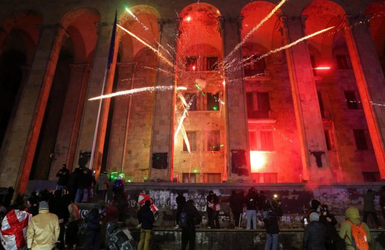 Fireworks explode in front of the parliament building during a protest against the new government's decision to suspend the European Union accession talks and refuse budgetary grants until 2028, in Tbilisi, Georgia December 1, 2024. REUTERS/Irakli Gedenidze