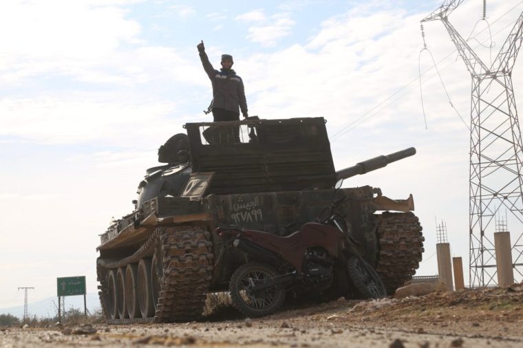 HAMA, SYRIA - DECEMBER 4: Armed groups, opposing Syria's Bashar al-Assad regime, capture tanks and military vehicles belonging to the regime forces on the Idlib-Hama road, in Hama, Syria on December 4, 2024. Anti-regime armed groups clashed with Assad regime forces about 5 kilometers outside the city center of Hama in Syria and took control of 4 more villages. (Photo by Kasim Rammah/Anadolu via Getty Images)