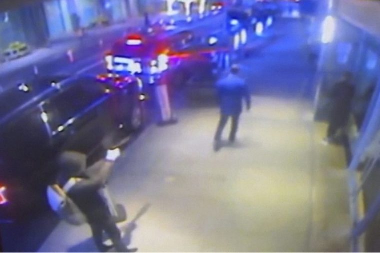 This still image from surveillance video obtained by the Associated Press shows the suspect, left, sought in the the killing of UnitedHealthcare CEO Brian Thompson, center, outside a Manhattan hotel where the health insurer was holding an investor conference, Wednesday, Dec. 4, 2024. (AP Photo)