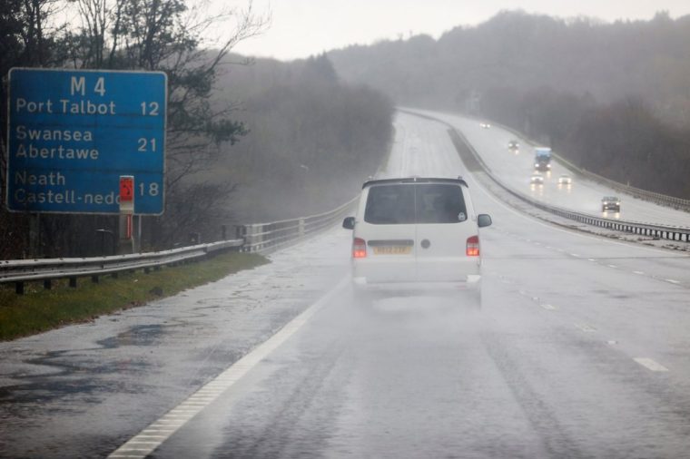 A vehicle drives through the storm after Storm Darragh hit the country, near Porthcawl, Wales, Britain, December 7, 2024. REUTERS/Temilade Adelaja