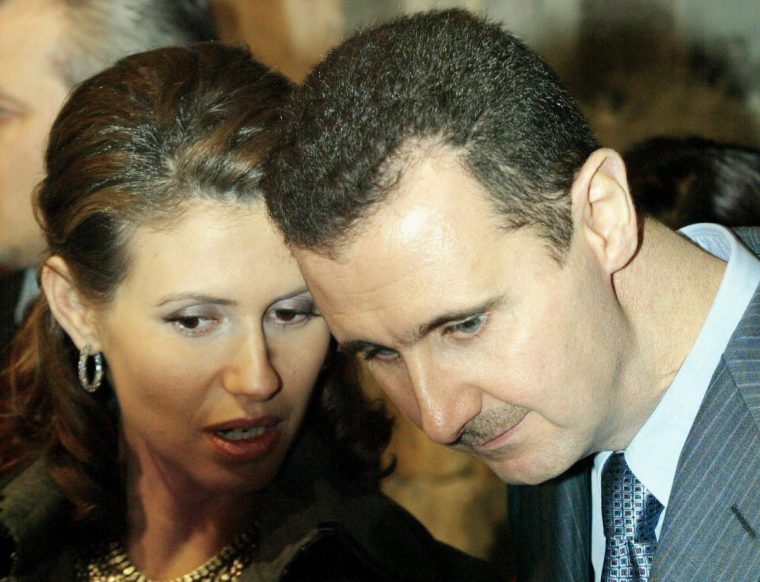 (FILES) Syrian President Bashar al-Assad and his wife Asma tour the Old City in Damascus with a visiting Turkish delegation headed by the prime minister and his wife (not pictured) on December 22, 2004. Islamist-led rebels declared that they have taken Damascus in a lightning offensive on December 8, 2024, sending Assad fleeing and ending five decades of Baath rule in Syria. (Photo by Louai Beshara / AFP) (Photo by LOUAI BESHARA/AFP via Getty Images)