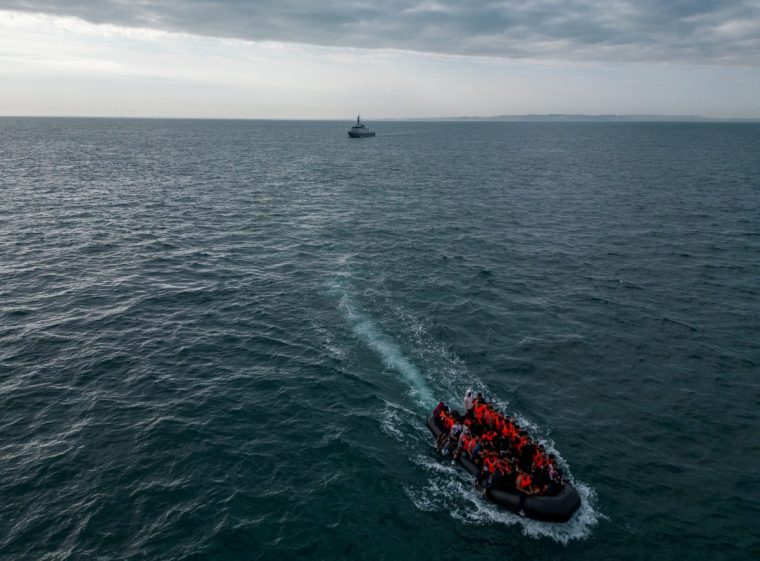 FILE PHOTO: In this drone view, an inflatable dinghy carrying migrants makes its way towards England in the English Channel, Britain, August 6, 2024. REUTERS/Chris J. Ratcliffe/File Photo