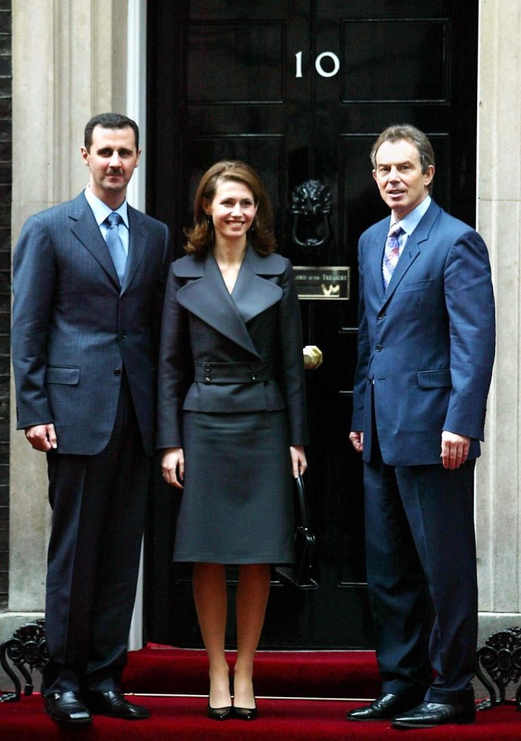 (FILES) Syria's ousted president Bashar al-Assad (L) poses at No.10 Downing Street in London with his wife Asma and then British Prime Minister Tony Blair December 16, 2002. Once seen as an advocate of women's rights in the Middle East, Syria's British-born former first lady Asma al-Assad has fled into exile with her husband, with UK officials saying she is not welcome home. (Photo by GERRY PENNY / AFP) (Photo by GERRY PENNY/AFP via Getty Images)