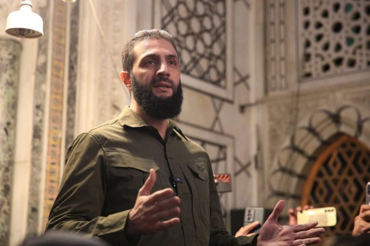 TOPSHOT - The leader of Syria's Islamist Hayat Tahrir al-Sham (HTS) group that headed a lightning rebel offensive snatching Damascus from government control, Abu Mohammed al-Jolani, address a crowd at the capital's landmark Umayyad Mosque on December 8, 2024. Jolani, now using his real name Ahmed al-Sharaa, gave a speech as the crowd chanted "Allahu akbar (God is greatest)," a video shared by the rebels on their Telegram channel showed. (Photo by Aref TAMMAWI / AFP) (Photo by AREF TAMMAWI/AFP via Getty Images)