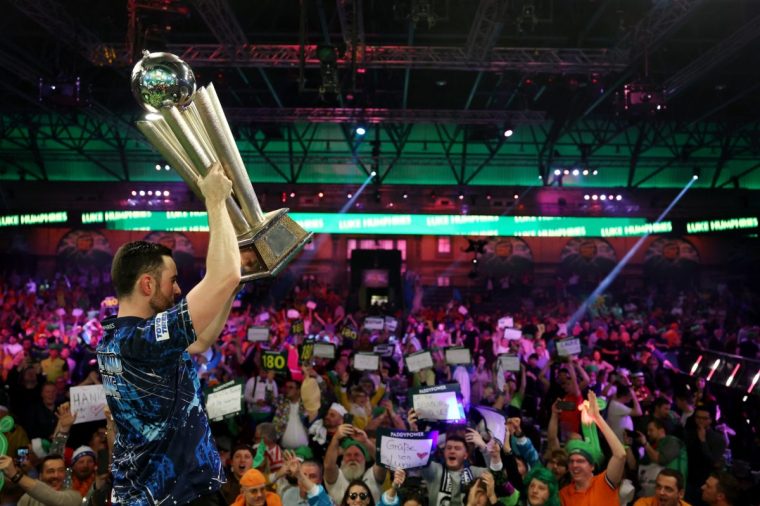 LONDON, ENGLAND - JANUARY 03: Luke Humphries of England celebrates victory with the trophy after winning the 2023/24 Paddy Power World Darts Championship Final against Luke Littler of England on Day Sixteen of the 2023/24 Paddy Power World Darts Championship at Alexandra Palace on January 03, 2024 in London, England. (Photo by Tom Dulat/Getty Images)