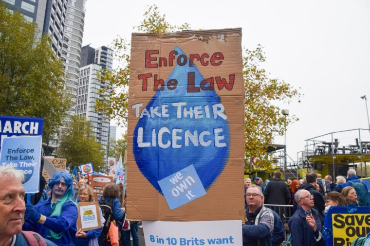 LONDON, UNITED KINGDOM - 2024/11/03: A protester calls for water companies to be made public during the March For Clean Water. Thousands of people marched in Central London calling on the government to act on clean water and end the dumping of sewage in British waters. (Photo by Vuk Valcic/SOPA Images/LightRocket via Getty Images)