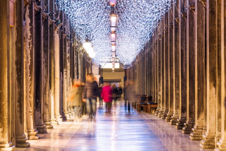 Italy, Veneto, Venice. St Marks square's colonnade, decorated with Christmas lights