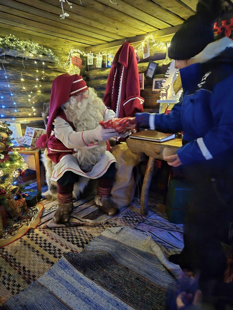 Father Christmas hands out gifts in his forest cabin (Photo: Sophie Lam)