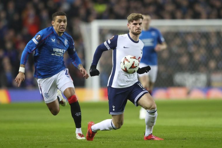 Tottenham's Timo Werner shields the ball from Rangers' James Tavernier during the Europa League opening phase soccer match between Glasgow Rangers and Tottenham Hotspur at Ibrox stadium in Glasgow, Thursday, Dec. 12, 2024. (AP Photo/Scott Heppell)