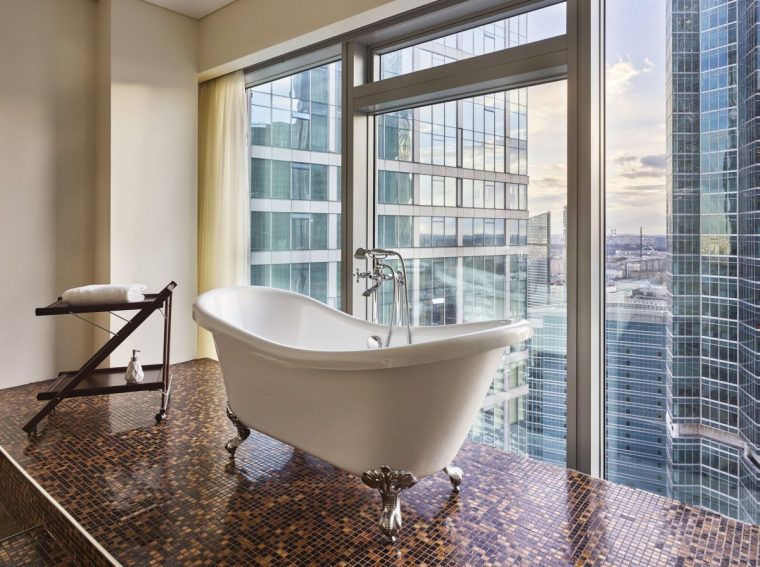 free-standing bath in the background of a window