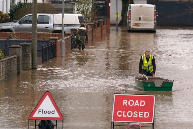 EMBARGOED TO 0001 TUESDAY DECEMBER 17 File photo dated 08/12/24 of a flood warden pushes a boat in floodwater in Greyfriars Avenue in Hereford, Herefordshire, after Storm Darragh hit the UK and Ireland. About one in five homes and businesses in England are in areas at risk of river, sea and flash flooding, analysis from the Environment Agency has warned. Issue date: Tuesday December 17, 2024. PA Photo. A major new update from the agency, which comes after widespread disruption and floods from storms Bert and Darragh, shows 6.3 million properties in England are in areas at risk of flooding from rivers, the sea or surface flooding, or a combination of different sources. See PA story ENVIRONMENT Flooding. Photo credit should read: Jacob King/PA Wire