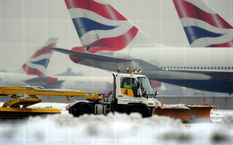 A worker operates a snow plough near the second runway, in an attempt to get it operational again, at Heathrow Airport, west of London, on December 21, 2010. Fresh snowfall added to the misery of thousands of Christmas travellers across Europe Tuesday, paralysing flights and trains as the EU lashed out at airports for "unacceptable" disruption. London Heathrow, where passengers have been forced to sleep on terminal floors during four days of chaos, cancelled two thirds of flights while Frankfurt closed for several hours after more snow fell overnight. AFP PHOTO / ADRIAN DENNIS (Photo credit should read ADRIAN DENNIS/AFP via Getty Images)