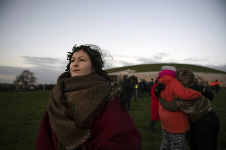 NEWGRANGE, IRELAND - DECEMBER 21: A young woman watches the sun come up as people gather to witness the winter solstice on December 21, 2022 in Newgrange, Ireland. Crowds are gathering at Newgrange in Co Meath, this morning for the winter solstice - the astronomical phenomenon that marks the shortest day and the longest night of the year. Newgrange is a Stone Age (Neolithic) monument in the Boyne Valley, County Meath, it is the jewel in the crown of Ireland's Ancient East and was constructed approximately 5,200 years ago (3,200 B.C.) which makes it older than Stonehenge and the Great Pyramids of Giza. (Photo by Charles McQuillan/Getty Images)