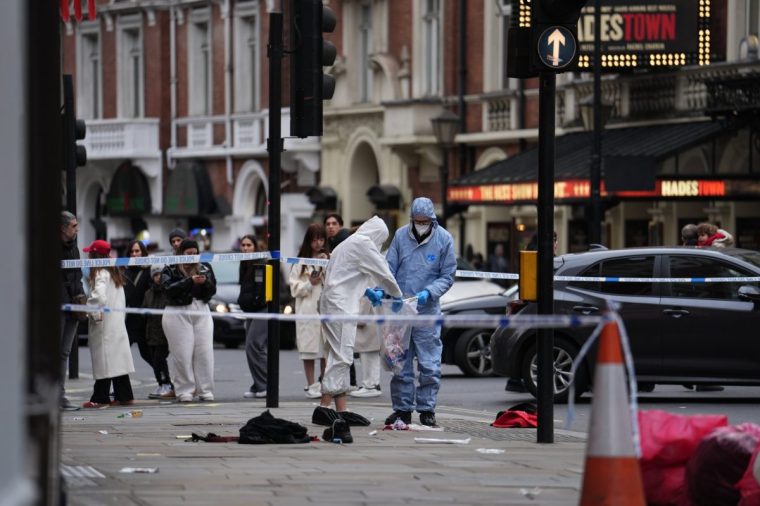 Forensic investigators collect evidence at the scene on Shaftesbury Avenue in central London after four people were injured, one seriously, by a car which was driven onto a pavement in central London in the early hours of Christmas Day. A 31-year-old man has been arrested on suspicion of attempted murder. Picture date: Wednesday December 25, 2024. PA Photo. See PA story POLICE Shaftesbury. Photo credit should read: Jordan Pettitt/PA Wire