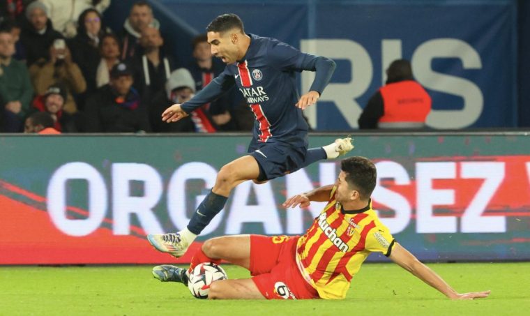 PARIS, FRANCE - NOVEMBER 02: Achraf Hakimi #2 of Paris Saint-Germain is eject by Abdu kodir Khusanov #25 of Lens during the Ligue 1 McDonald's match between Paris Saint-Germain and Racing Club de Lens at Parc des Princes Stadium on November 02, 2024 in Paris, France. (Photo by Xavier Laine/Getty Images)