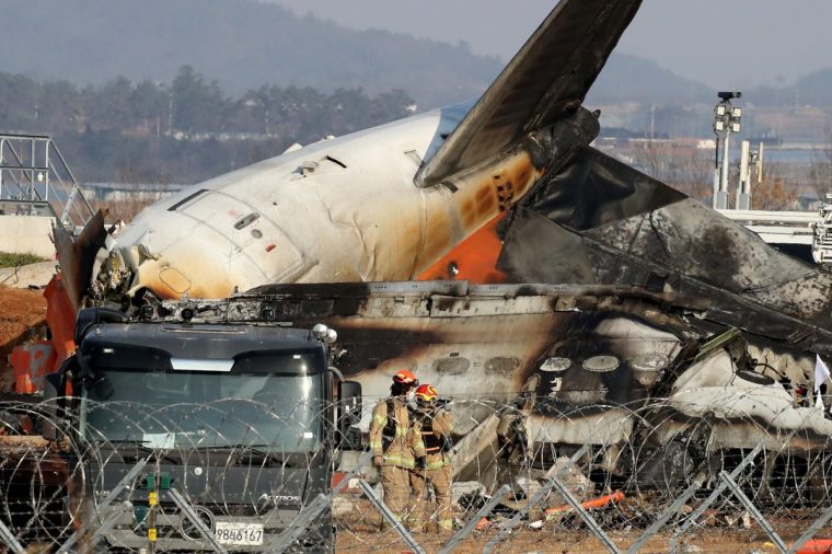 MUAN-GUN, SOUTH KOREA - DECEMBER 29: Firefighters and rescue teams work at the wreckage of a passenger plane at Muan International Airport on December 29, 2024 in Muan-gun, South Korea. A plane carrying 181 people, Jeju Air Flight 7C2216, crashed at Muan International Airport in South Korea after skidding off the runway and colliding with a wall, resulting in an explosion. Latest reports said that at least 179 people had died. (Photo by Chung Sung-Jun/Getty Images)