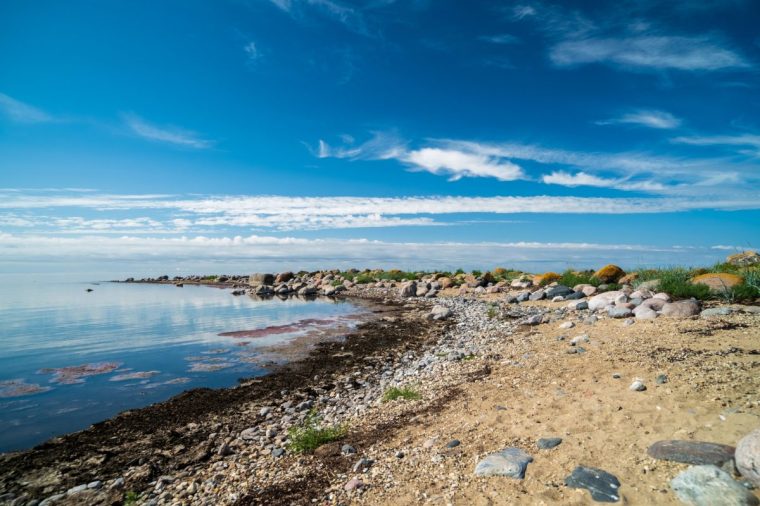 The rocky shore of the Baltic Sea. Beautiful sunny summer day, calm sea. Baltic Sea Estonia Kihnu Island.