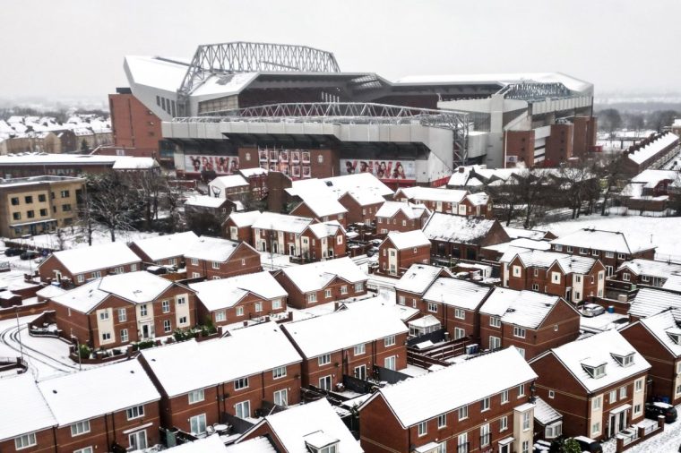 An aerial photograph taken on January 5, 2025 shows Anfield stadium in Liverpool, north west England, covered in snow ahead of the the English Premier League football match between Liverpool and Manchester United, as heavy snow across parts of England are set to cause disruption. An amber weather warning -- the second most serious -- for snow and freezing rain was in place for much of Wales, central England and parts of northwestern England. (Photo by Darren Staples / AFP) (Photo by DARREN STAPLES/AFP via Getty Images)