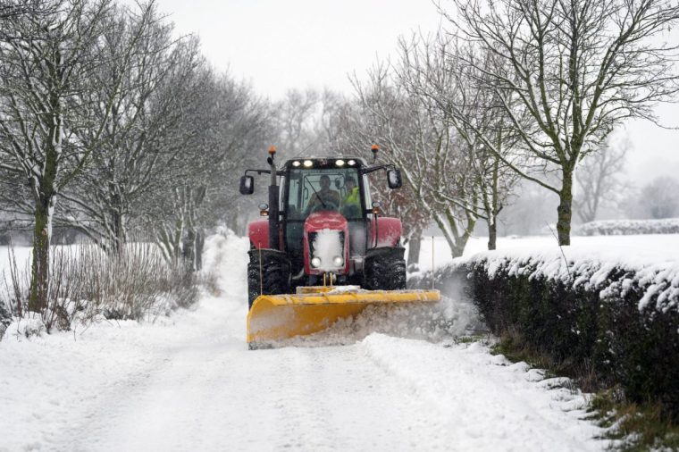 A tractor clears snow from a road in Scotton, Harrogate, North Yorkshire. Heavy overnight snow is causing disruption across the UK as the cold start to the new year continues. Picture date: Sunday January 5, 2025. PA Photo. Two amber weather warnings from the Met Office have been put in place in England and Wales, with 3cm to 7cm of snowfall predicted for much of the affected area, mixing with rain at times in lower-lying areas. The Met Office said Bingley, West Yorkshire, had seen 12cm of snow up to 7am on Sunday, with Shap in Cumbria and Capel Curig, Gwynedd, both seeing 10cm. One amber warning for snow and freezing rain, which covers much of Wales and the Midlands as far north as Manchester, is in place until midday on Sunday. See PA story WEATHER Winter. Photo credit should read: Danny Lawson/PA Wire