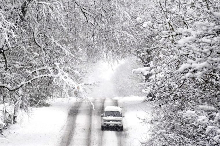 A vehicle is driven along a snow covered road in Scotton, Harrogate, North Yorkshire. Heavy overnight snow is causing disruption across the UK as the cold start to the new year continues. Picture date: Sunday January 5, 2025. PA Photo. Two amber weather warnings from the Met Office have been put in place in England and Wales, with 3cm to 7cm of snowfall predicted for much of the affected area, mixing with rain at times in lower-lying areas. The Met Office said Bingley, West Yorkshire, had seen 12cm of snow up to 7am on Sunday, with Shap in Cumbria and Capel Curig, Gwynedd, both seeing 10cm. One amber warning for snow and freezing rain, which covers much of Wales and the Midlands as far north as Manchester, is in place until midday on Sunday. See PA story WEATHER Winter. Photo credit should read: Danny Lawson/PA Wire