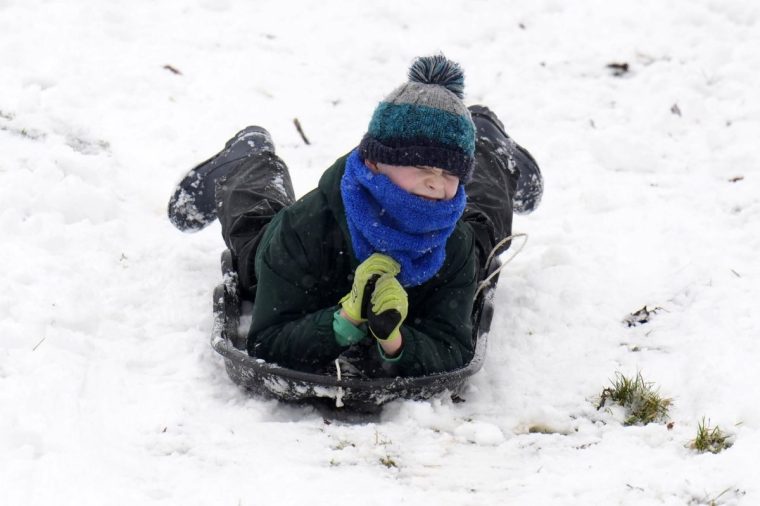 PARENTAL PERMISSION GIVEN Oscar Meadley, sledges in Studley Royal park in North Yorkshire. Heavy overnight snow is causing disruption across the UK as the cold start to the new year continues. Picture date: Sunday January 5, 2025. PA Photo. Two amber weather warnings from the Met Office have been put in place in England and Wales, with 3cm to 7cm of snowfall predicted for much of the affected area, mixing with rain at times in lower-lying areas. The Met Office said Bingley, West Yorkshire, had seen 12cm of snow up to 7am on Sunday, with Shap in Cumbria and Capel Curig, Gwynedd, both seeing 10cm. One amber warning for snow and freezing rain, which covers much of Wales and the Midlands as far north as Manchester, is in place until midday on Sunday. See PA story WEATHER Winter. Photo credit should read: Danny Lawson/PA Wire