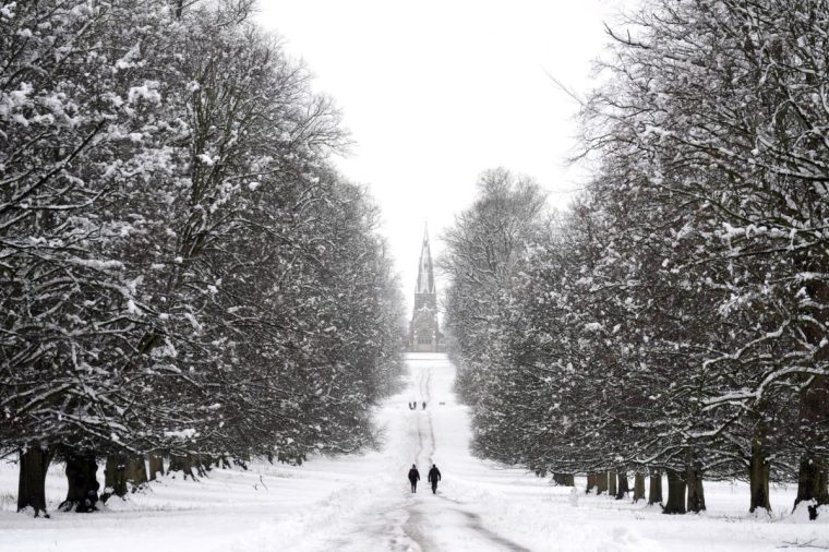 People walking in the snow in Studley Royal park in North Yorkshire. Heavy overnight snow is causing disruption across the UK as the cold start to the new year continues. Picture date: Sunday January 5, 2025. PA Photo. Two amber weather warnings from the Met Office have been put in place in England and Wales, with 3cm to 7cm of snowfall predicted for much of the affected area, mixing with rain at times in lower-lying areas. The Met Office said Bingley, West Yorkshire, had seen 12cm of snow up to 7am on Sunday, with Shap in Cumbria and Capel Curig, Gwynedd, both seeing 10cm. One amber warning for snow and freezing rain, which covers much of Wales and the Midlands as far north as Manchester, is in place until midday on Sunday. See PA story WEATHER Winter. Photo credit should read: Danny Lawson/PA Wire