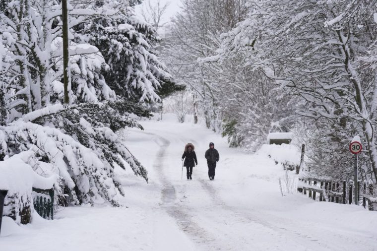 People walk in the snow near Allenheads, in the Pennines in Northumberland. Weather warnings remain in force across much of the UK on Monday with adverse conditions, including flooding from heavy rain and thawing snow. Picture date: Monday January 6, 2025. PA Photo. Photo credit should read: Owen Humphreys/PA Wire