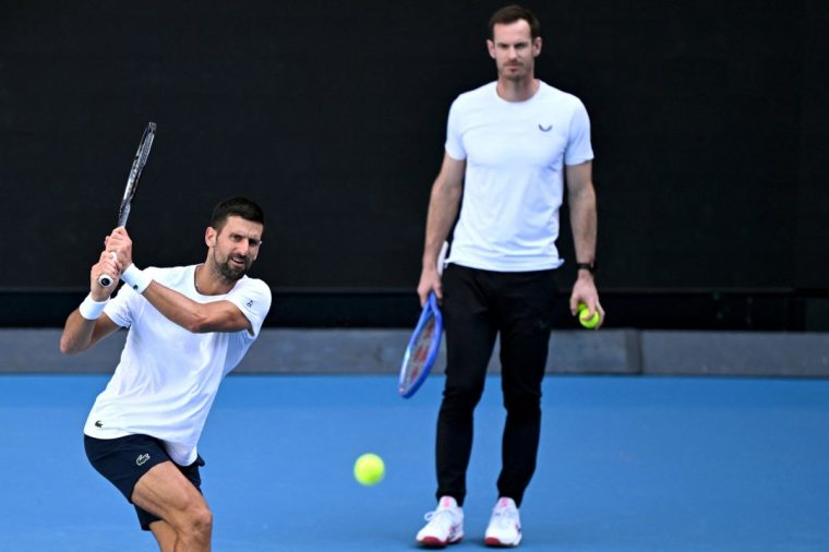 Novak Djokovic of Serbia (L) hits a return as coach Andy Murray (R) looks on during a training session ahead of the Australian Open tennis tournament in Melbourne on January 7, 2025. (Photo by William WEST / AFP) / --IMAGE RESTRICTED TO EDITORIAL USE - STRICTLY NO COMMERCIAL USE-- (Photo by WILLIAM WEST/AFP via Getty Images)