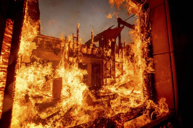 The Palisades Fire burns a residence in the Pacific Palisades neighborhood of Los Angeles, Tuesday, Jan. 7, 2025. (AP Photo/Ethan Swope)