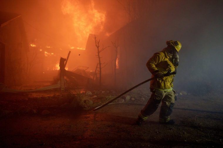 LOS ANGELES, CALIFORNIA - JANUARY 7: A firefighter battles flames from the Palisades Fire on January 7, 2025 in the Pacific Palisades neighborhood of Los Angeles, California. Fueled by intense Santa Ana Winds, the Palisades Fire has grown to over 2,900 acres and nearly 30,000 people have evacuated while a second fire has emerged near Eaton Canyon. (Photo by Eric Thayer/Getty Images)