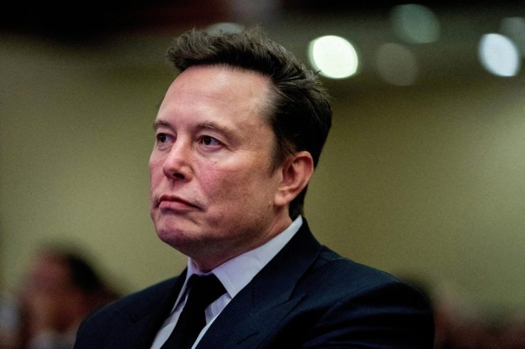 FILE PHOTO: Tesla CEO and X owner Elon Musk listens as US President-elect Donald Trump speaks during a meeting with House Republicans at the Hyatt Regency hotel in Washington, DC, U.S. on November 13, 2024. ALLISON ROBBERT/Pool via REUTERS//File Photo