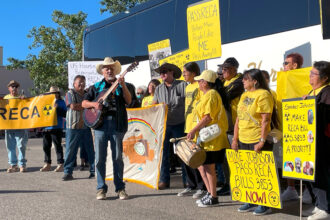 Supporters of the Radiation Exposure Compensation Act sing about saving the program on Sept. 22 before leaving Albuquerque, New Mexico for Washington, D.C. Credit: Noel Lyn Smith/Inside Climate News