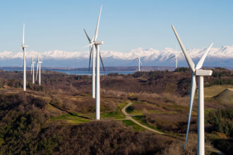 Wind turbines spin on Alaska’s Fire Island in 2022. Cook Inlet Region, which owns most of the island, built the 17.6MW project a decade ago and is looking at options to triple the power output. Credit: Loren Holmes/ADN