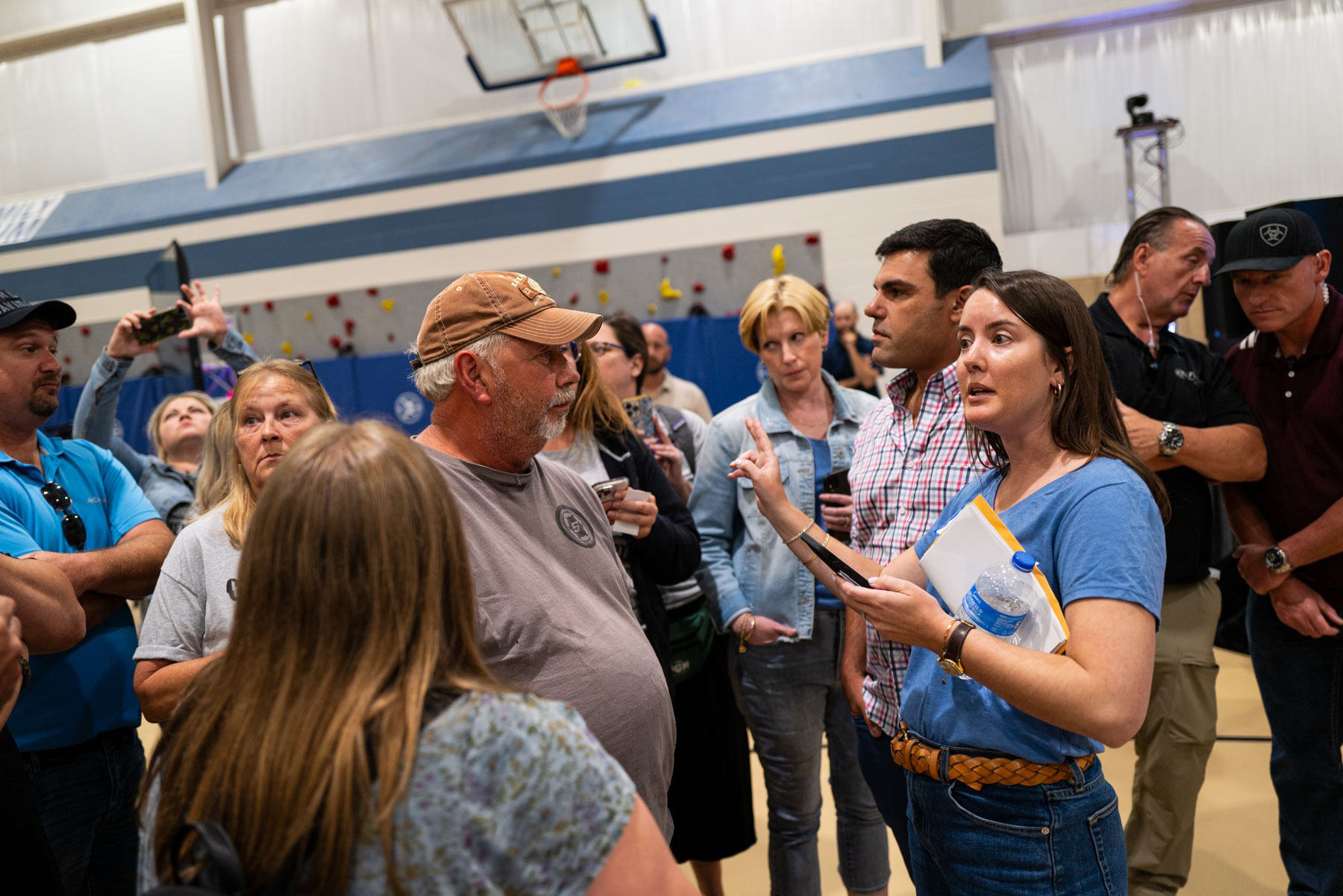 Toby Rice, in plaid, is confronted by residents of New Freeport, Pennsylvania, last year, after residents reported water contamination in the wake of an EQT fracking mishap in Greene County. Credit: Quinn Glabicki/PublicSource