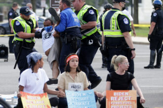 U.S. Capitol Police arrest a climate activist during a protest on Capitol Hill in 2021. Credit: Alex Wong/Getty Images