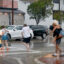 People make their way through heavy rain as streets begin to flood on June 12 in Miami Beach. The plaintiffs are all residents of the jurisdiction that the complaint points out is uniquely vulnerable to hotter temperatures, rising seas and more damaging storms. Credit: Joe Raedle/Getty Images